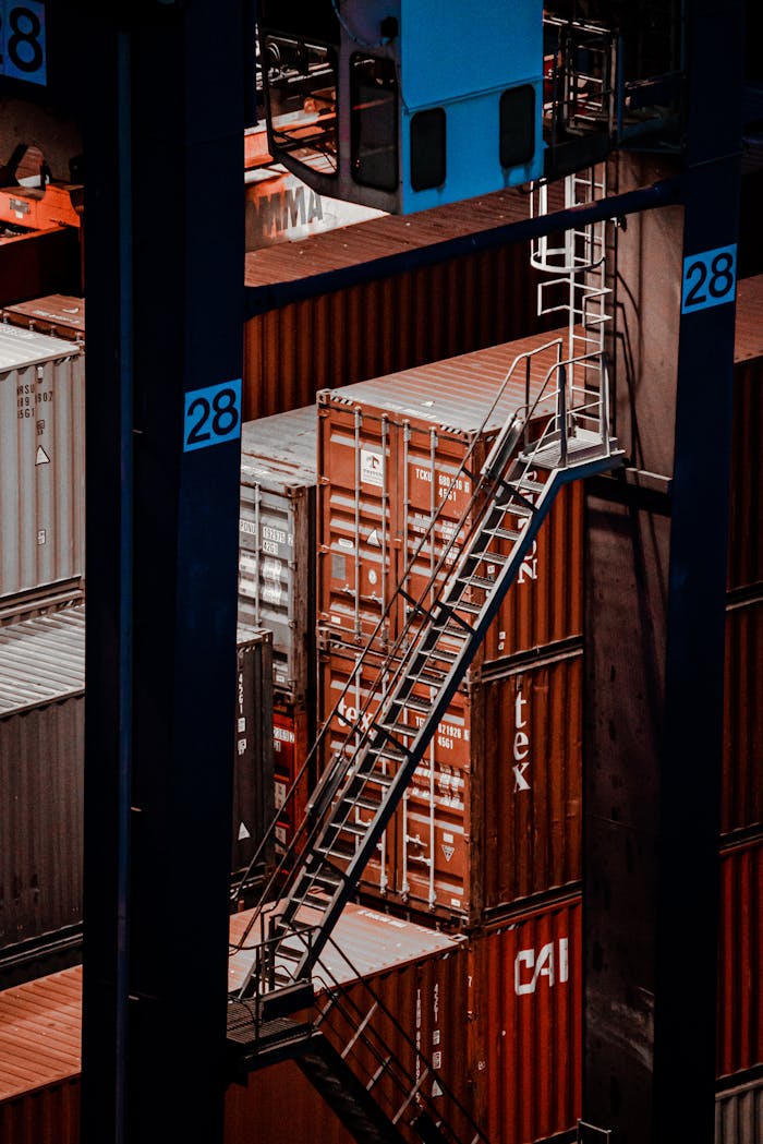 why-choose-us Elevated view of cargo containers with a metal staircase at a shipping facility.